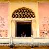 amber-fort-man-peers-through-window-jaipur