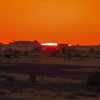 sun-dips-belowe-buildings-jaisalmer-desert