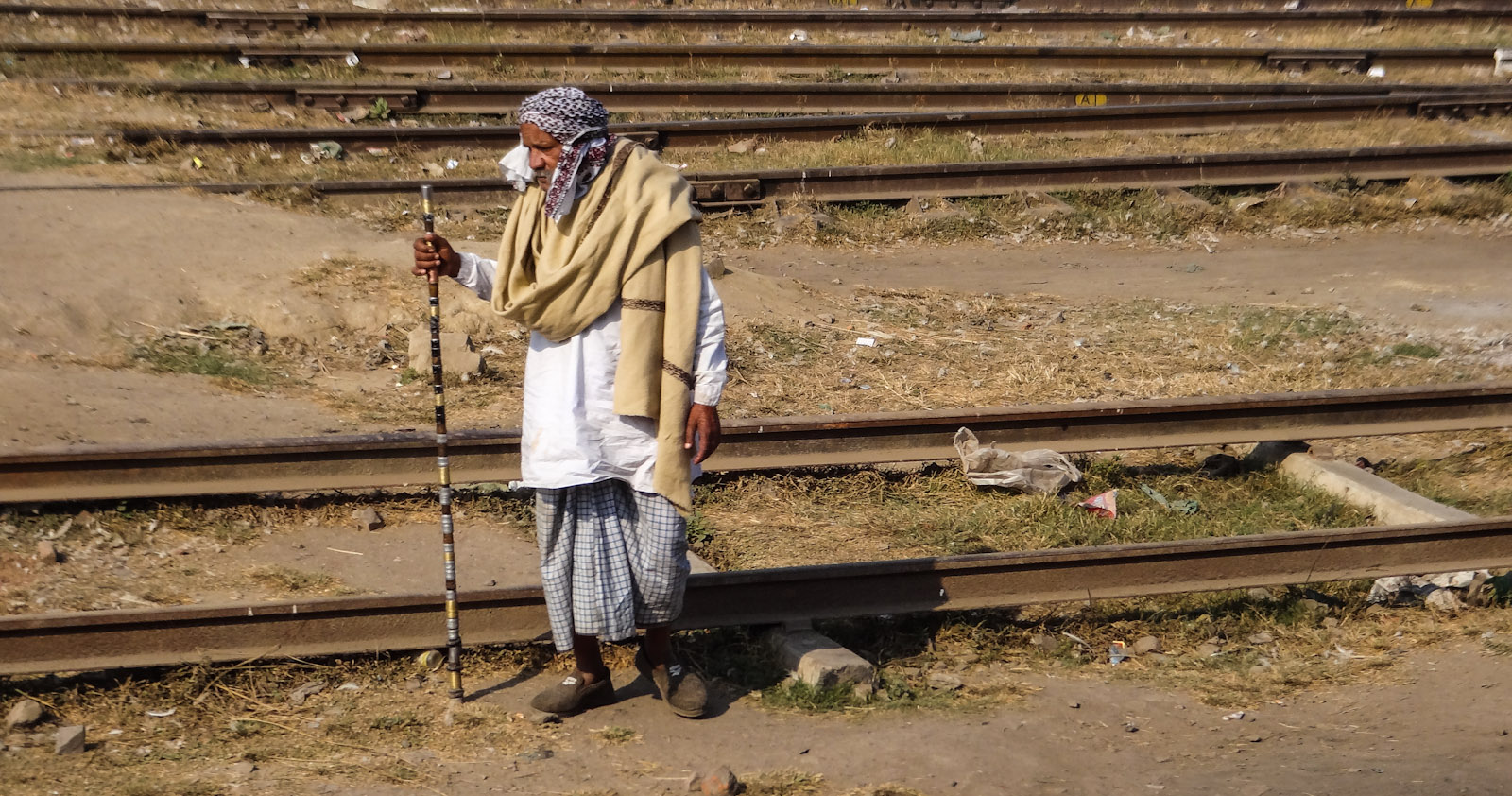old-man-by-railroad-india