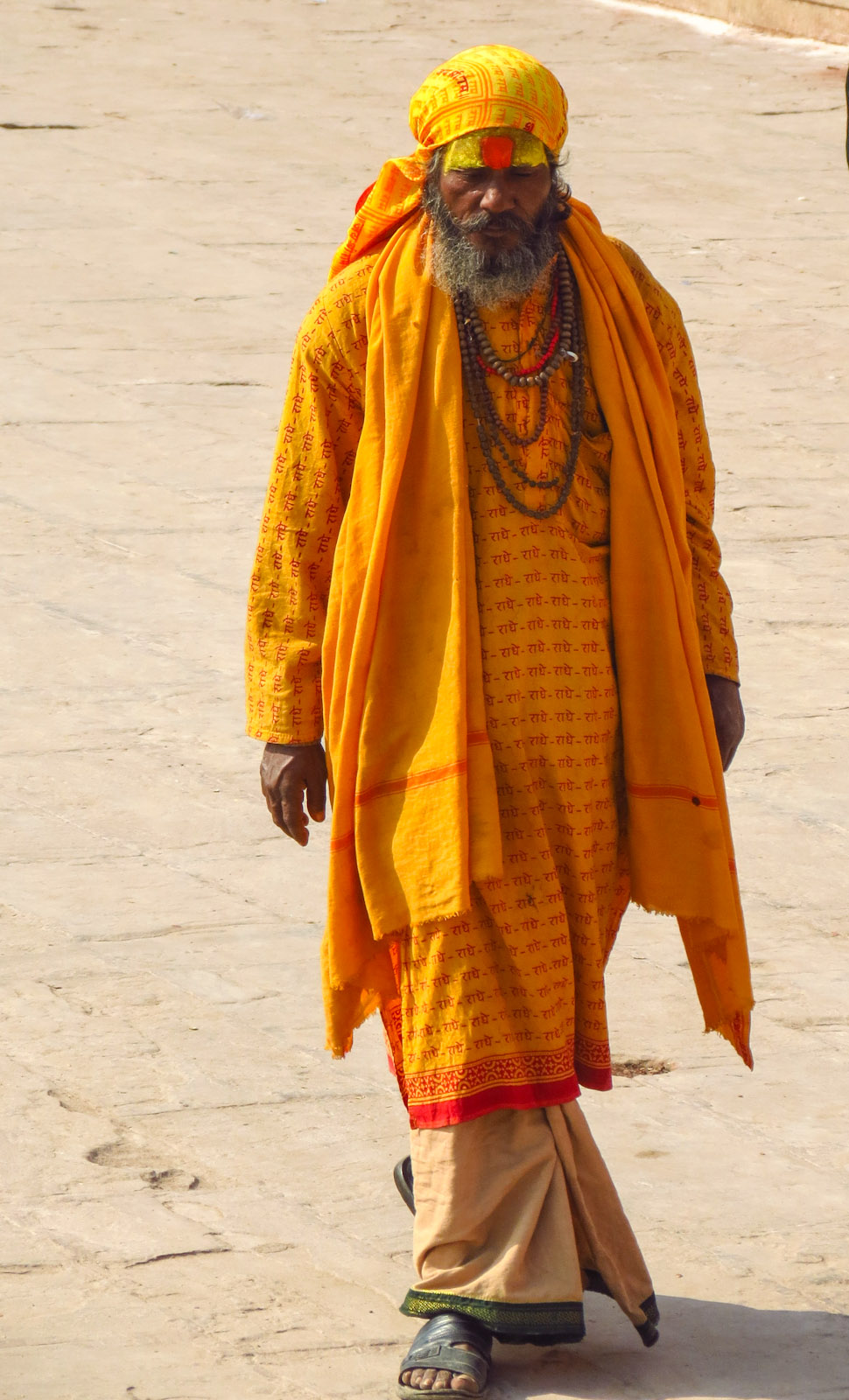 pilgrim-in-saffron-walking-along-ghats-varanasi