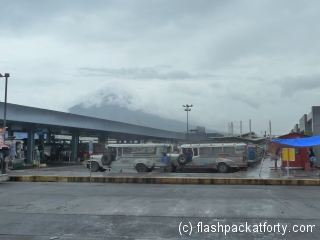legapazi-bus-and-jeepney-terminal-with-volcano-under-clouds
