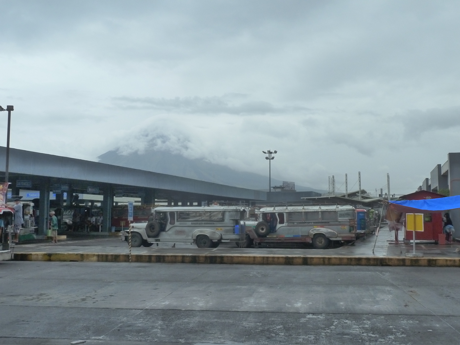 legapazi-bus-and-jeepney-terminal-with-volcano-under-clouds