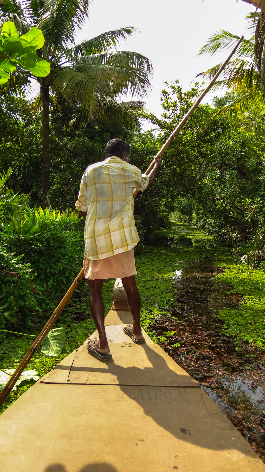 boatman-guides-us-down-narrow-waterway-kerala-backwaters