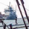 man-on-chinese-fishing-nets-fort-cochi