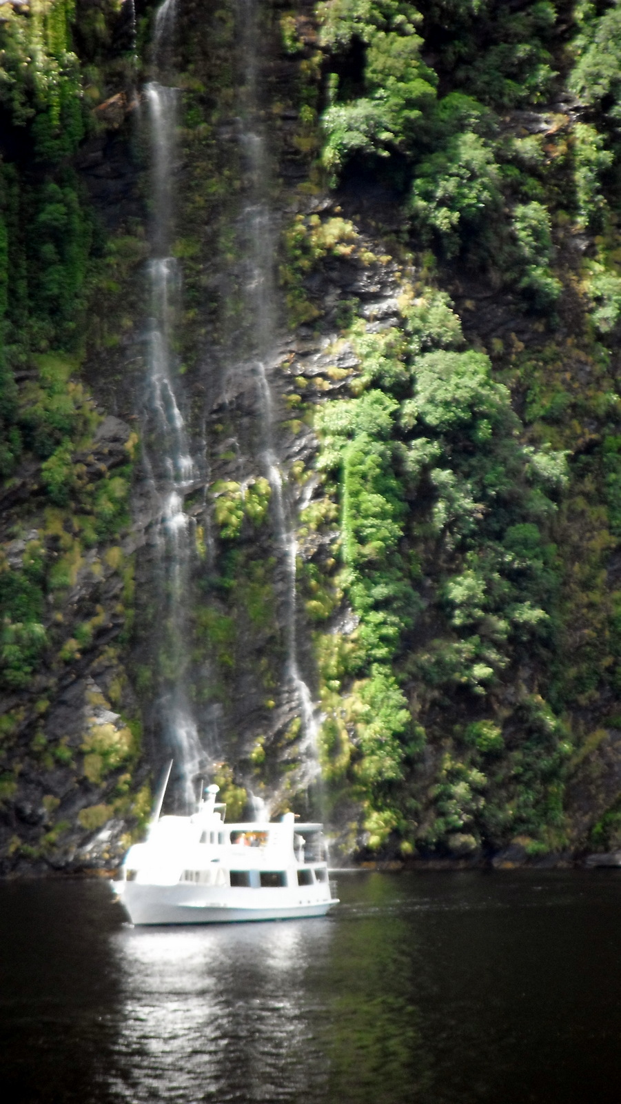 doubtful-sound-boat-and-waterfall