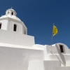 white-church-and-flags-karterados-santorini
