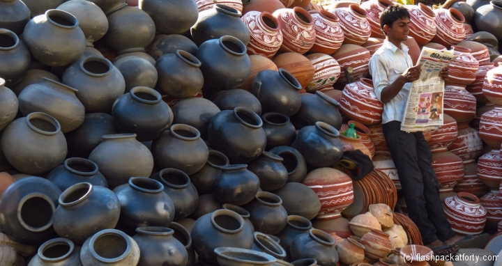 urn-seller-reads-paper-udaipur-india